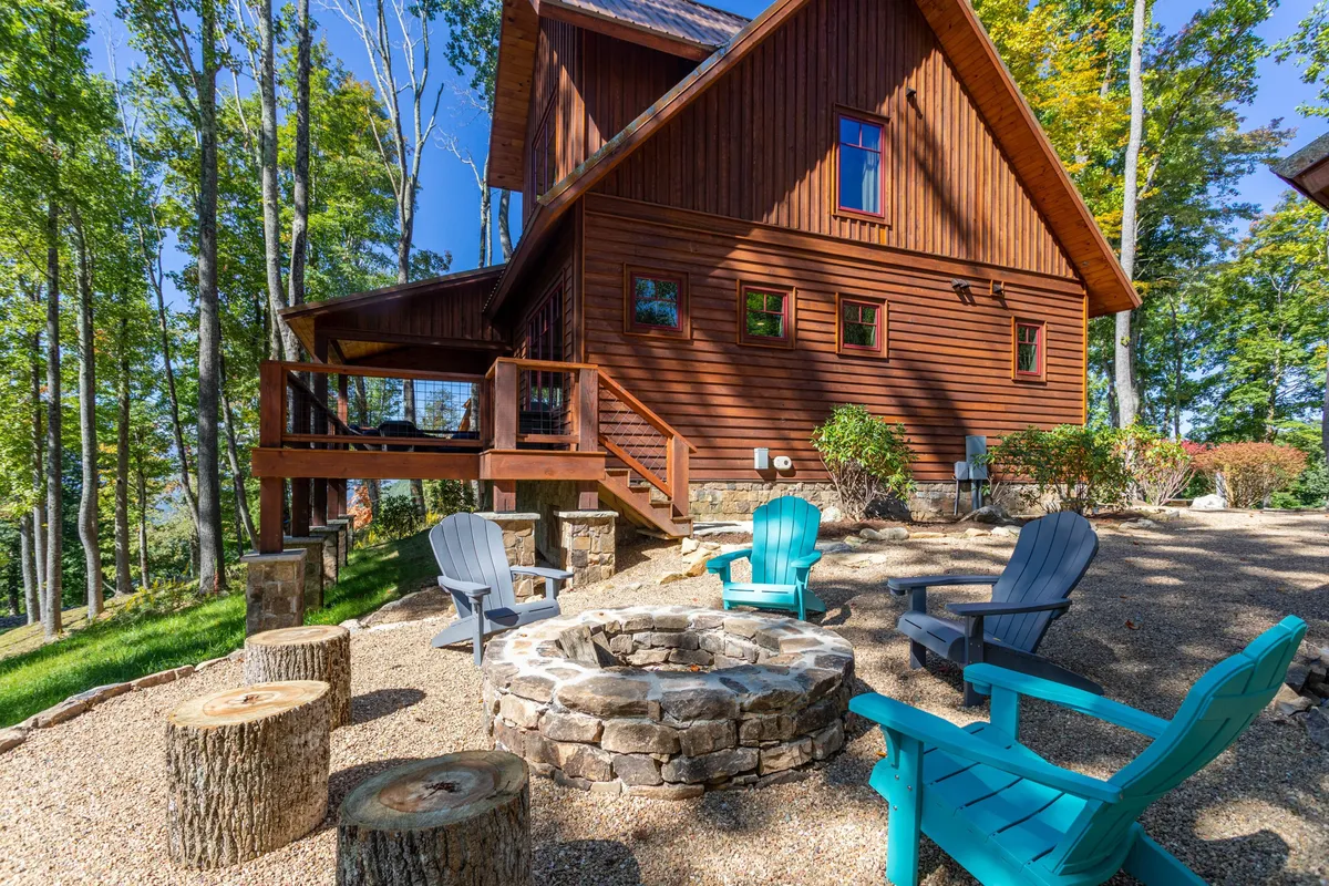 An exterior shot with a fire pit, Adirondack chairs, wooden house, and a forested backdrop. The setting invites group games, sunset watching, and stargazing, echoing the playful, adventure-filled spirit of the section.